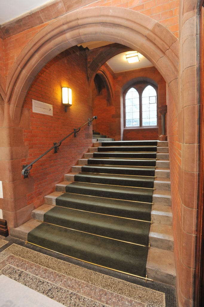 Solid brass stair runner rods fitted to period stone staircase