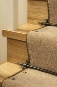 carpet studs antique brass attached to beige stair runner