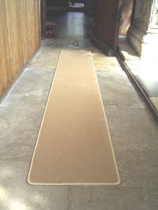 easybind edging a beige runner in a church