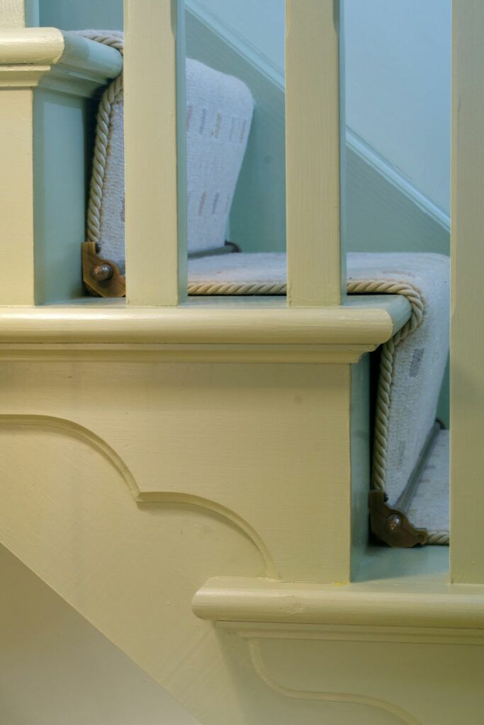 Cream stair runner edged with Easybind carpet binding on stairs with spindles