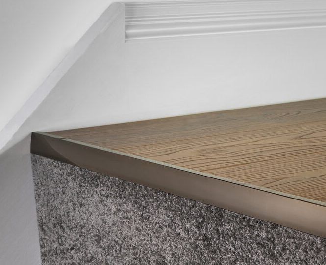 laminate stair nose in antique joins laminate to carpet riser