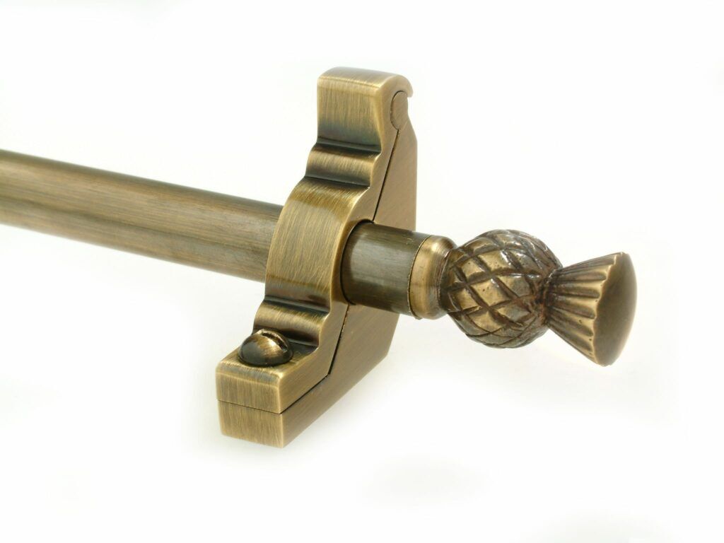 stair rod in antique brass with a thistle-styled end section