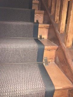 Vintage stair rods shown on wooden staircase