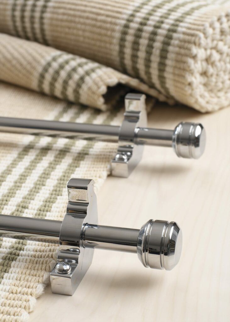 Piston stair rods polished chrome on striped carpet