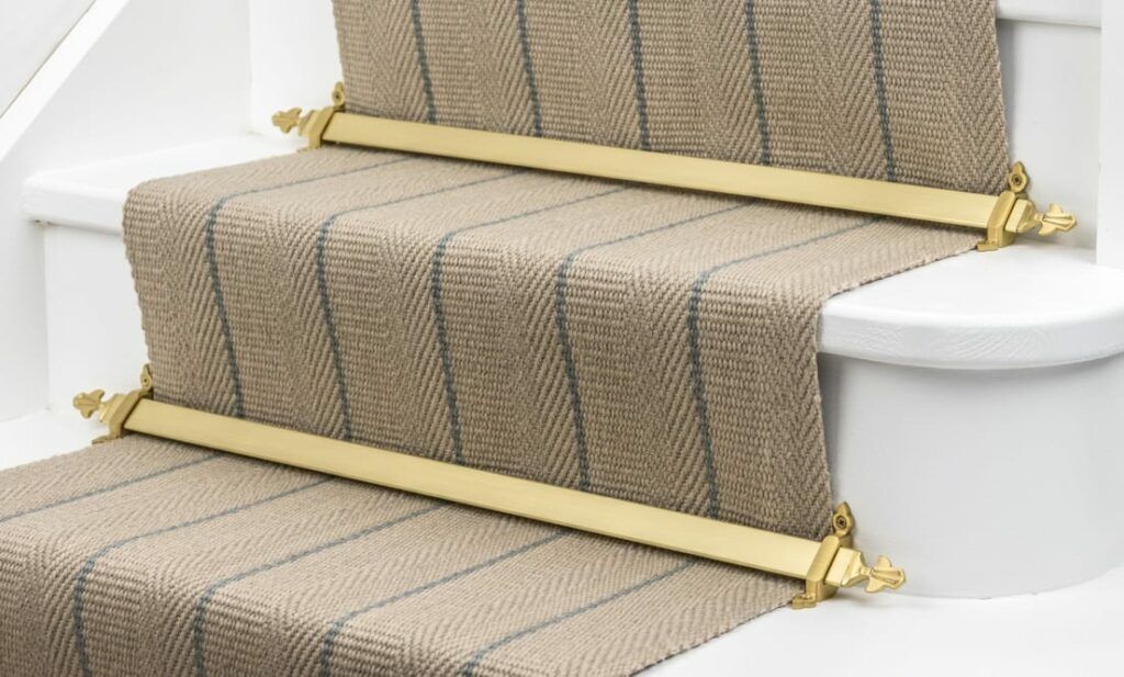 Louis stair carpet bars in polished brass on striped, natural runner