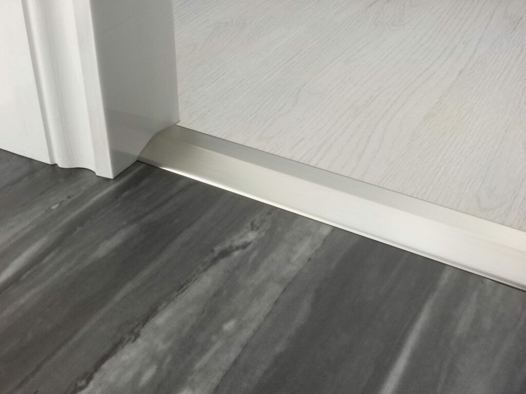 Premier 2 Way Ramp sloping door threshold, shown from laminate to vinyl, satin nickel