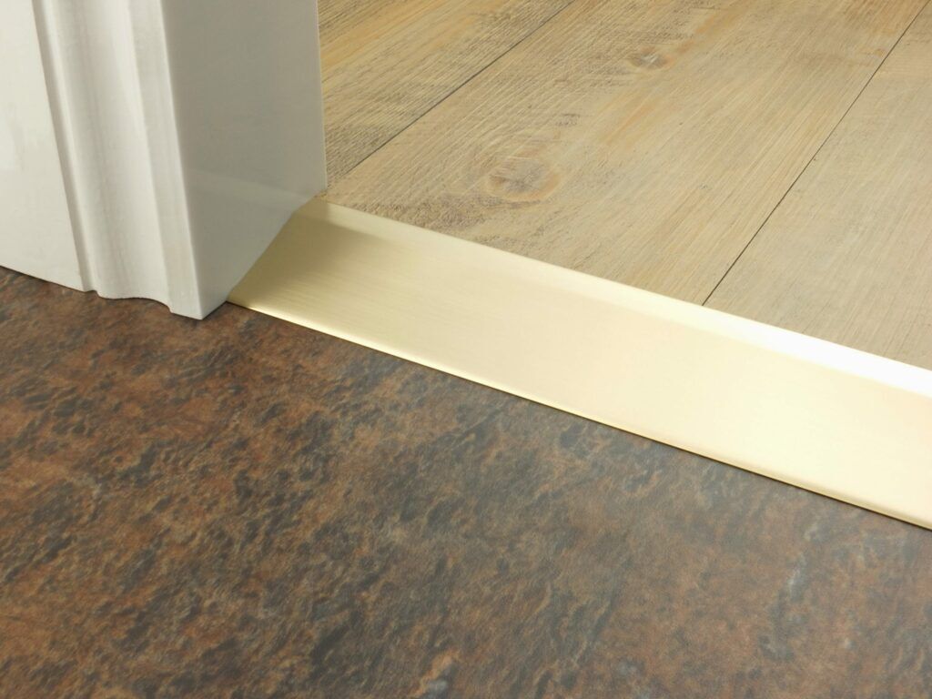 Premier Ramp 20mm sloping door threshold, shown from laminate to vinyl in satin brass