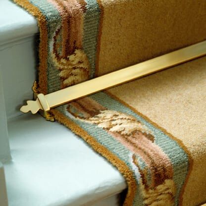 Beaumont stair rods in polished brass on bordered runner