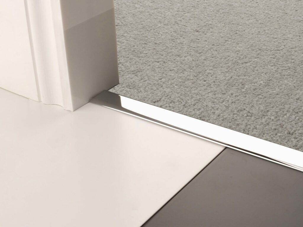 Premier Z chrome flooring joiner between tiles and a carpet