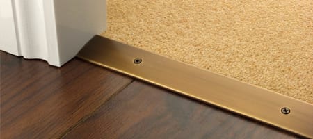 How to install a door threshold is made simple with these Premier Cover plates with matching screws in antique bronze joining carpet to wood