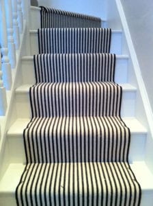 Black and white striped stair runner decorated with chrome Easy studs on each step