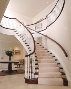 Dubai stair carpet rods on grand winding staircase with cream carpet