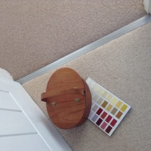 Internal door bar cob=nnecting 2 beige carpets with colour chart on carpet
