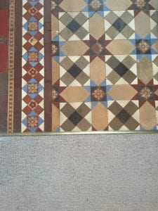 Premier Z9 threshold transition strip in antique brass joining carpet to patterned tiled floor