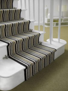 Sphere design of runner stair rods with spherical ends and brackets, fitted on green and black striped stair runner