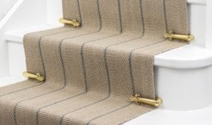 Victorian Stair Clips in polished brass on striped stair runner