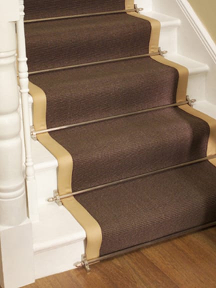 satin nickel stair carpet rods fitted to dark brown stair runner on white staircase