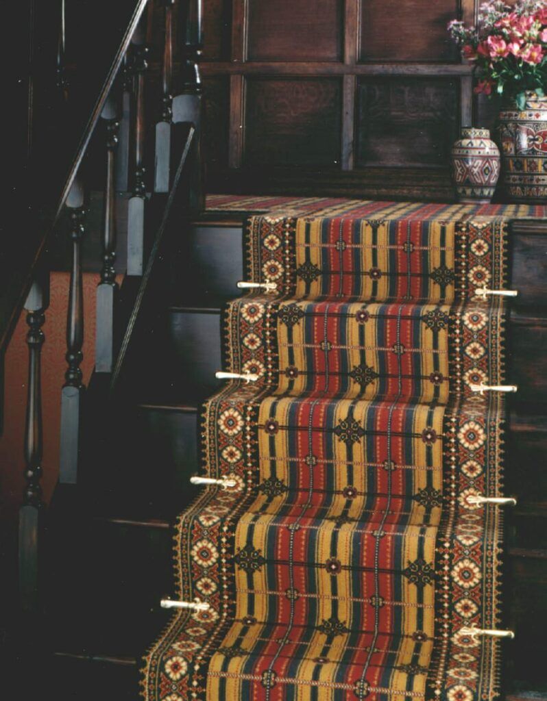 Victorian stair carpet clips enhance a runner stair carpet